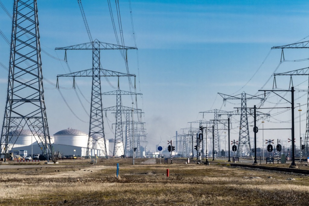 Aerial view of industrial site with high-voltage transmission infrastructure